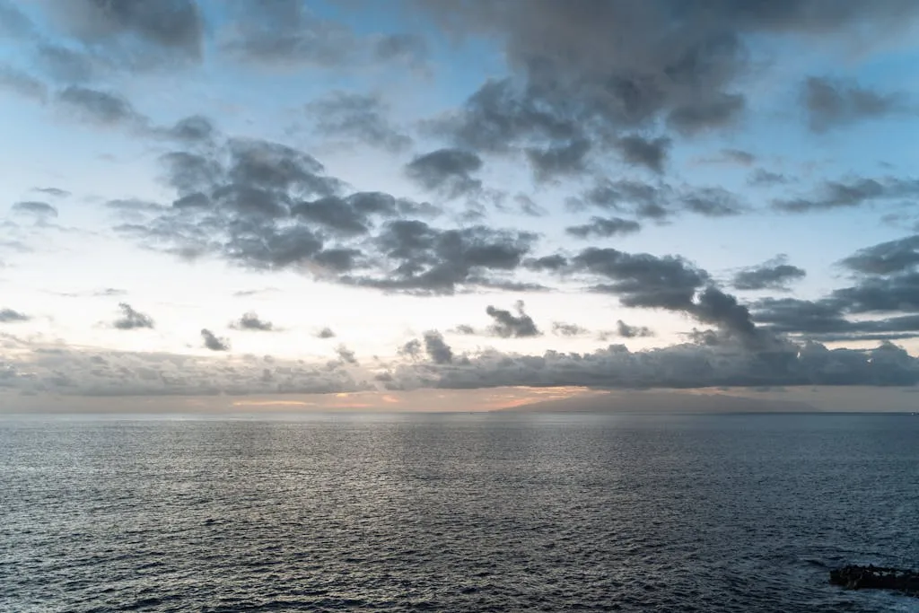 Calm Atlantic Ocean under a dramatic twilight sky, capturing a tranquil evening scene.