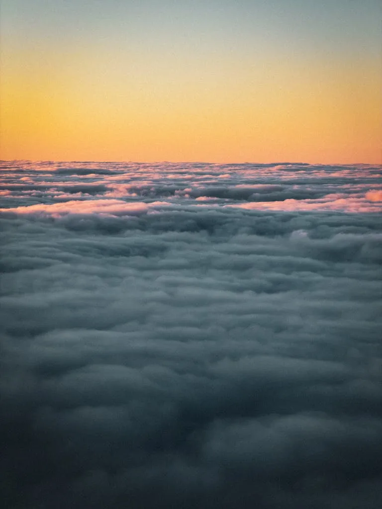 Vibrant aerial photo showcasing clouds at sunrise over Tenerife, Canary Islands, Spain.